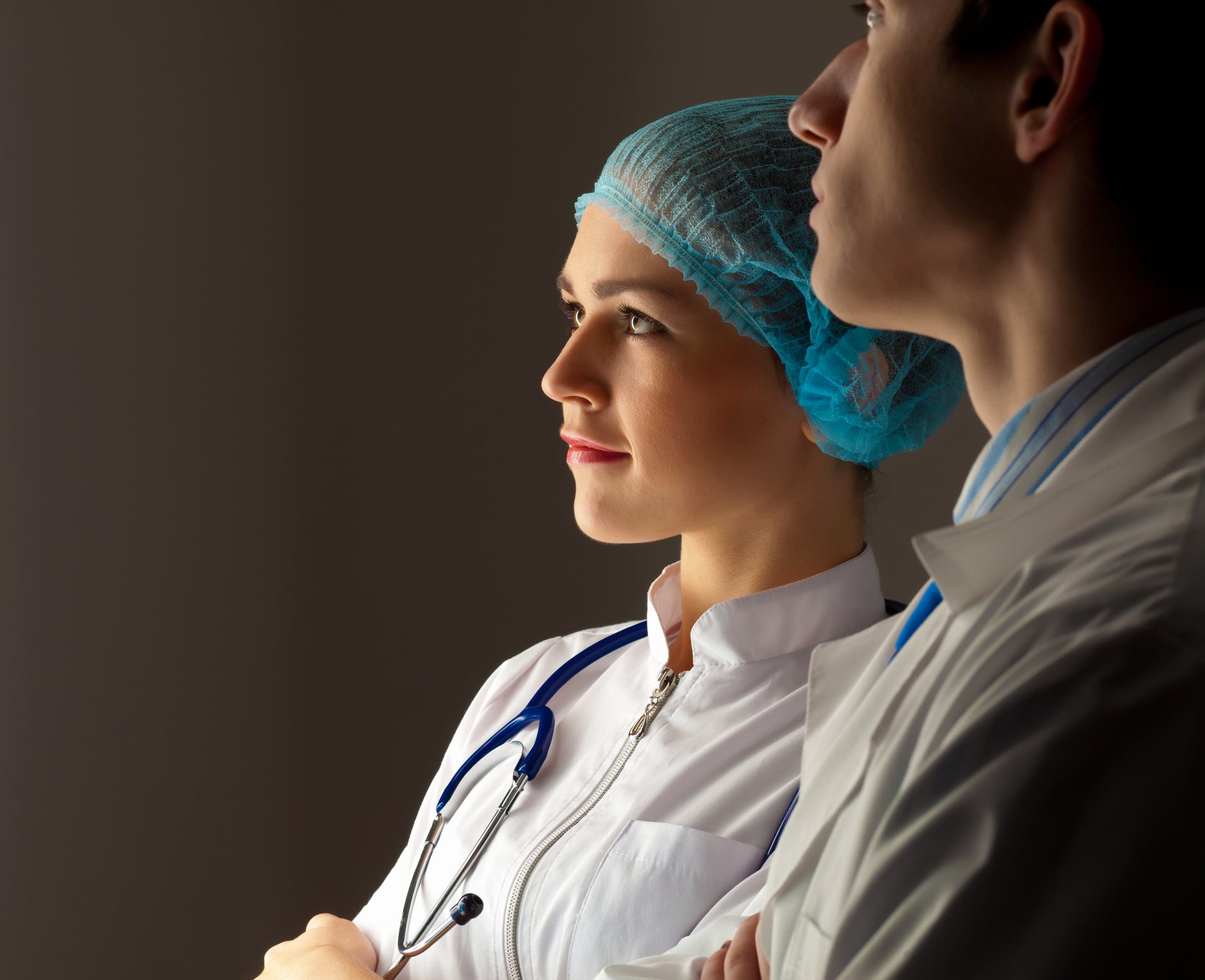 Two clinicians reviewing outpatient operations and diagnostic records together